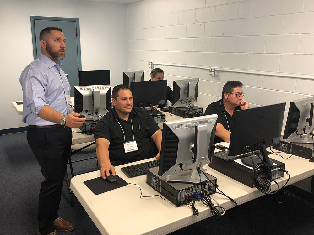 Med Vest Technology Oncology Services employees receive live training in a classroom setting.